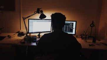 man using computer inside room