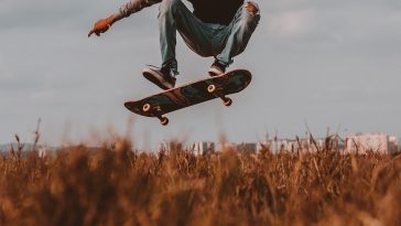 man performing skateboard trick during daytime