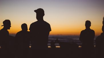 silhouette group of people under sunset