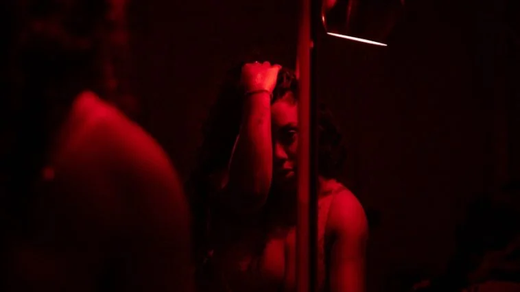 person holding lighted cigarette stick